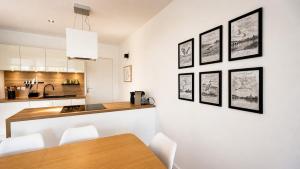 a kitchen with a table and some pictures on the wall at Les Oiseaux de Loire in Les Ponts-de-Cé +24 photos