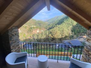 a room with a balcony with a view of a mountain at Varanda do Brejo in Seia