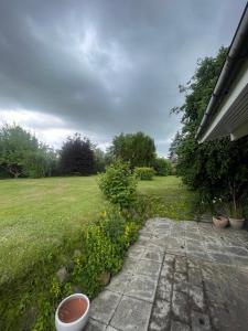 a garden with flowers in a yard with a field at Spacious Holiday Home With Large Plot By Buresø in Slangerup