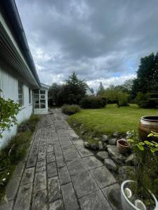 a brick walkway in front of a house at Spacious Holiday Home With Large Plot By Buresø in Slangerup