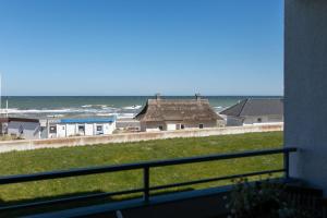 a view of the ocean from the balcony of a house at Strandhotel Dahme TraumMeerBlick in Dahme