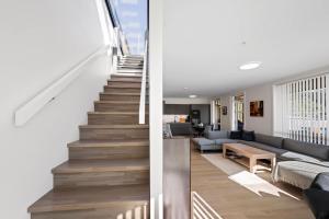 a staircase leading up to a living room and a house at Penthouse with Rooftop Terrace & Balcony in Bergen
