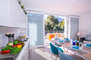 a kitchen and living room with a table with vegetables on it at Casa Laura Apt. 6 in Menaggio