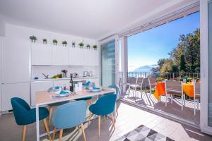 a kitchen with a table and chairs and a large window at Casa Laura Apt. 6 in Menaggio