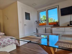 a room with a glass table and a bed at Mały Domek in Szczecinek +8 photos