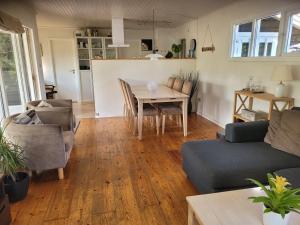 a living room with a couch and a table at Natural Plot Fireplace And True West Coast in Thisted