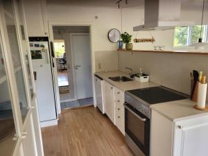 a kitchen with a sink and a stove at Natural Plot Fireplace And True West Coast in Thisted +6 photos