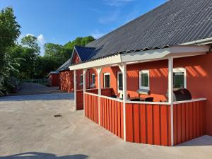 a red house with a black roof at Idyllic Country Apartment Incl All Utilities in Christiansfeld