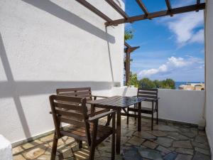 a patio with a table and chairs on a balcony at Anna Traditional Apartments in Kamari