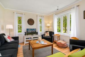 a living room with a couch and a table at Bertie Street Cottage in Chincoteague
