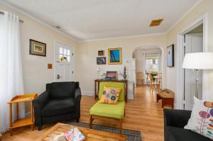 a living room with two chairs and a couch at Bertie Street Cottage in Chincoteague