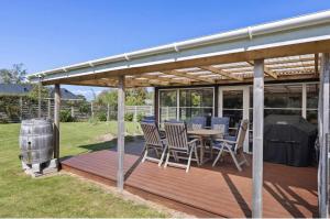 a pergola with a table and chairs on a deck at Close To The Beach With Outdoor Spa in Slagelse +14 photos