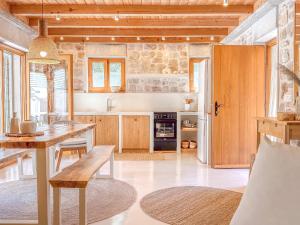 a kitchen with a wooden table and a dining room at Dolce Terra in Stari Grad