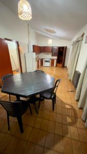 a dining room with a table and chairs and a kitchen at Dulce descanso 3 Bed and Breakfast in Salta