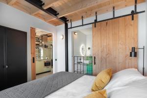 a bedroom with a large bed and wooden walls at Lennepserf - T Marsje in Veessen