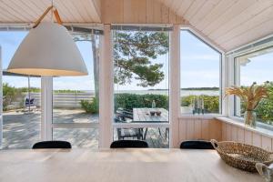 a dining room with a table and views of the ocean at Panoramic View And Denmarks Best Beach in Neksø +32 photos