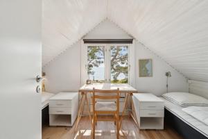 a room with a desk and a bed and a window at Panoramic View And Denmarks Best Beach in Neksø