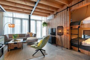 a living room with a bunk bed and a couch at Lennepserf - De Hoeven in Veessen +2 photos