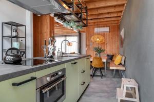 a kitchen with a sink and a stove top oven at Lennepserf - De Achterhoek in Veessen