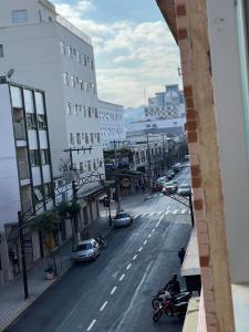 a view of a city street with cars and motorcycles at Suítes São Lourenço in São Lourenço