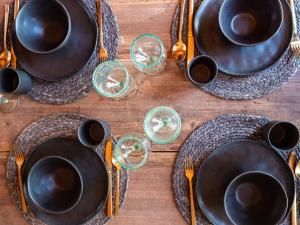 a wooden table with plates and cups and utensils at Lennepserf - De Horstjes in Veessen +9 photos