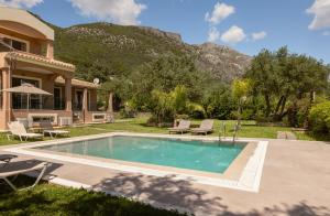 a house with a swimming pool in the yard at Villa Renata -Pool, Large Garden & Free Parking, 2 Minutes Walk from The Beach in Barbati