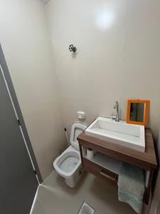 a bathroom with a sink and a toilet at Suítes São Lourenço in São Lourenço