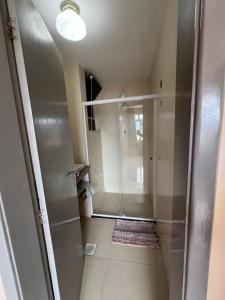 a bathroom with a walk in shower and a glass door at Suítes São Lourenço in São Lourenço