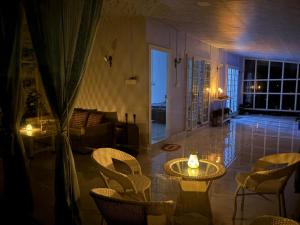 a living room with a table and chairs and a couch at Countryside Retreat in Pune