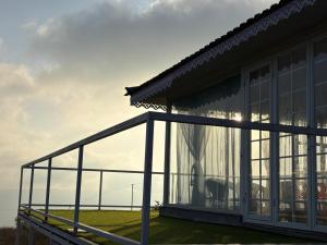 a balcony of a house with glass windows at Countryside Retreat in Pune