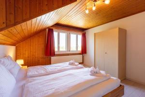 a bedroom with a large bed with towels on it at Hauswurz in Thun