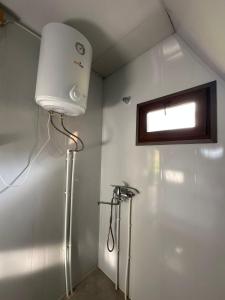 a white shower in a bathroom with a window at Cottage Caucasus in Ushguli +38 photos