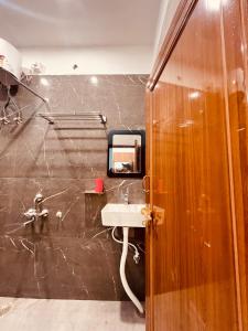 a bathroom with a sink and a mirror at ramraz residency in Ayodhya +44 photos