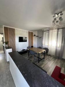 a living room with a table and a dining room at Theviennehouse in Cenon-sur-Vienne