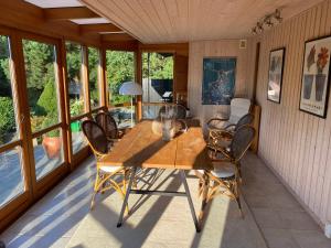 a dining room with a wooden table and chairs at Veddinge Odsherreddenmark - House With Seaview in Asnæs +13 photos