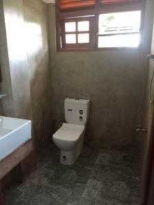 a bathroom with a toilet and a sink and a window at Kurana Resident in Katunayaka