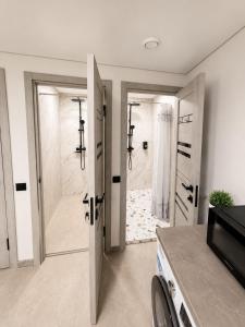a bathroom with a shower and a walk in shower stall at EVURI Rooms in Uzhhorod