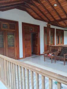 a porch of a house with wooden doors and benches at Kurana Resident in Katunayaka