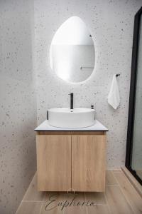 a bathroom with a sink and a mirror at Euphoria Central Living in Stavros +12 photos