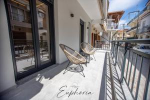 a couple of chairs sitting on a balcony at Euphoria Central Living in Stavros