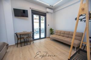 a living room with a couch and a table at Euphoria Central Living in Stavros