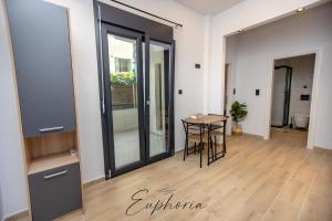 a room with a table and a glass door at Euphoria Central Living in Stavros