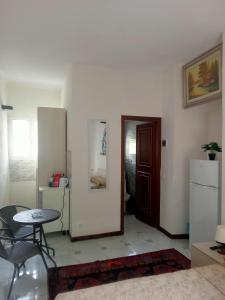 a living room with a table and a refrigerator at zahira in Biassa