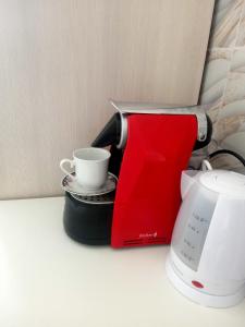 a coffee maker and a cup on a counter at zahira in Biassa
