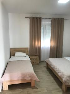a bedroom with two beds and a window at Apartments Suljovic in Ulcinj