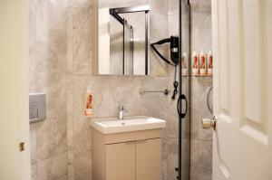 a bathroom with a sink and a shower at Kale Otel Bodrum in Bodrum City +29 photos