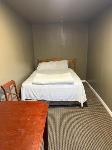 a bedroom with a bed and a wooden table at Plattsburgh Stay in Plattsburgh