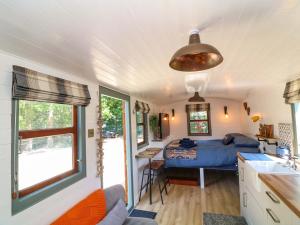 a small bedroom with a bed and a table at Lake View Shepherds Hut in Lincoln