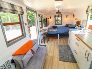 a kitchen and living room in a tiny house at Lake View Shepherds Hut in Lincoln
