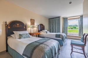 a hotel room with two beds and a window at 139 e 140 Casa dos Carvalhos in Castelo Branco +83 photos